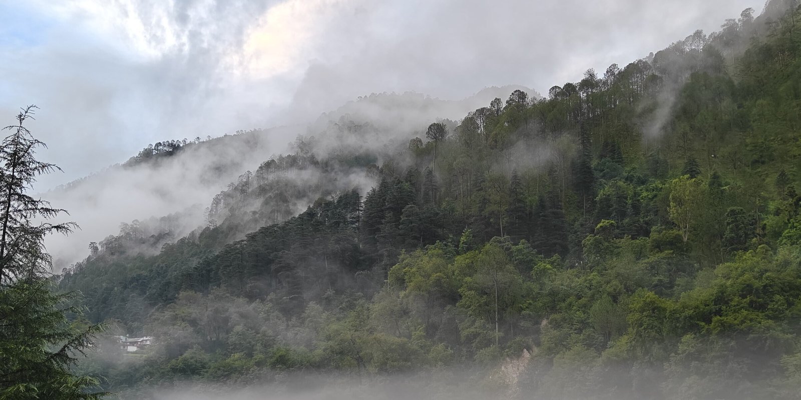 Misty Himalayan valley and river near Uttarkashi, mountains fading into cloud