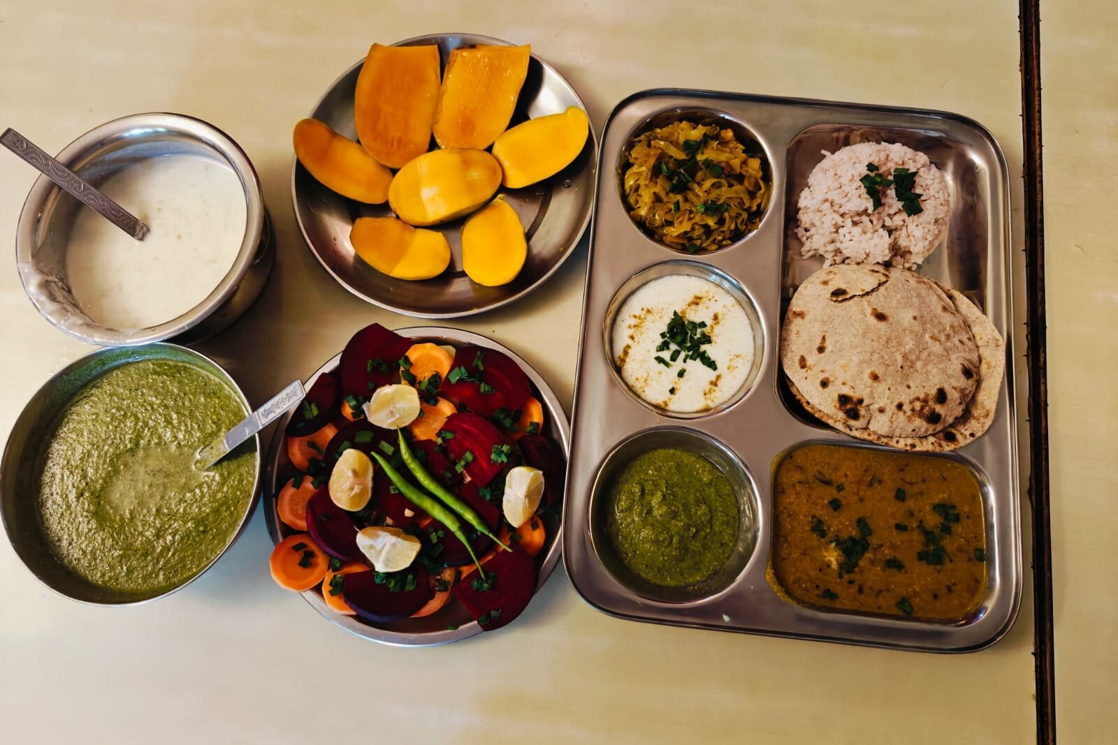 A vegetarian thali meal served during a residential programme at Uttarkashi, with rice, roti, dal, sabzi and salad