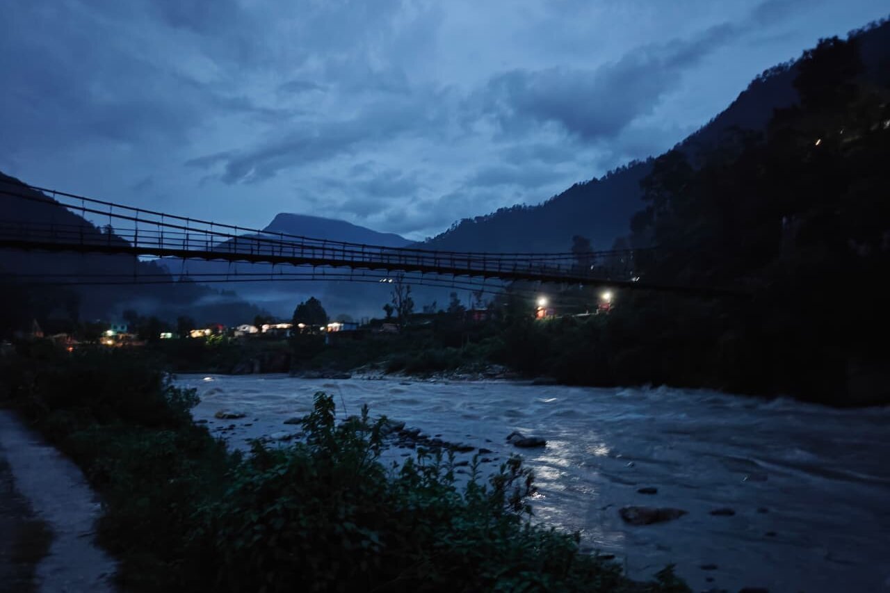 The Bhagirathi River at dusk, quiet and still beneath the hills near Uttarkashi