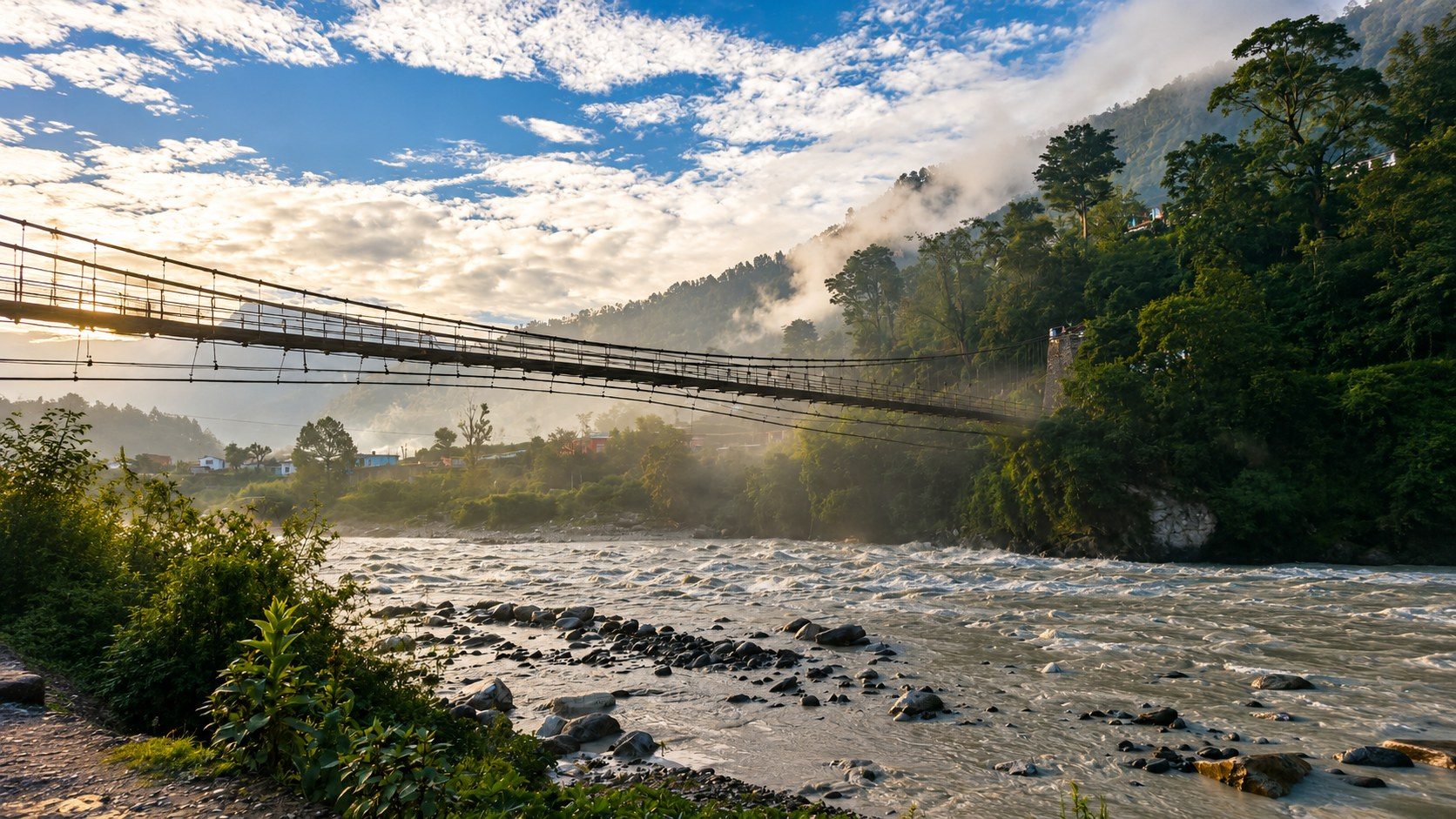 A misty suspension bridge over the Bhagirathi River in soft morning light near our residential campus in Uttarkashi