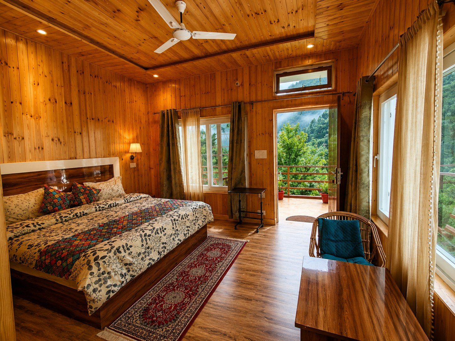 A wood-panelled room at our Uttarkashi campus with its own balcony opening onto misty forest