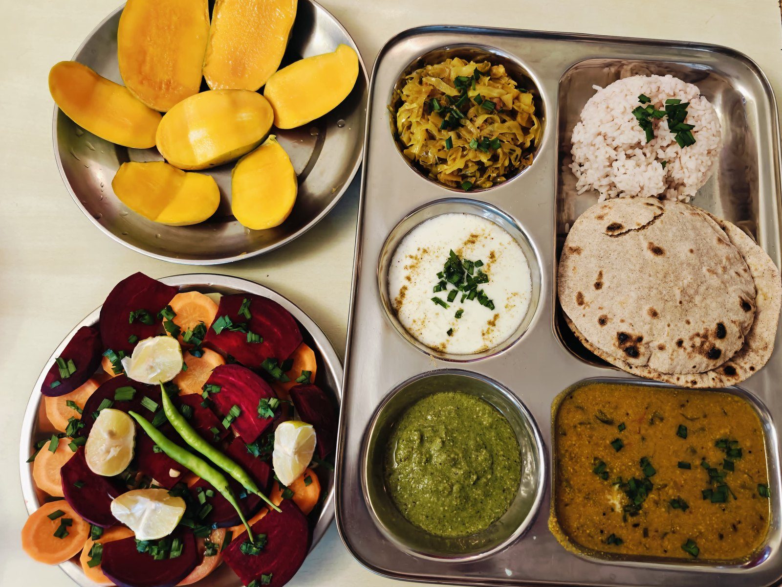 A seasonal vegetarian Himalayan thali — dal, rice, roti, sabzi and chutney served on a steel platter