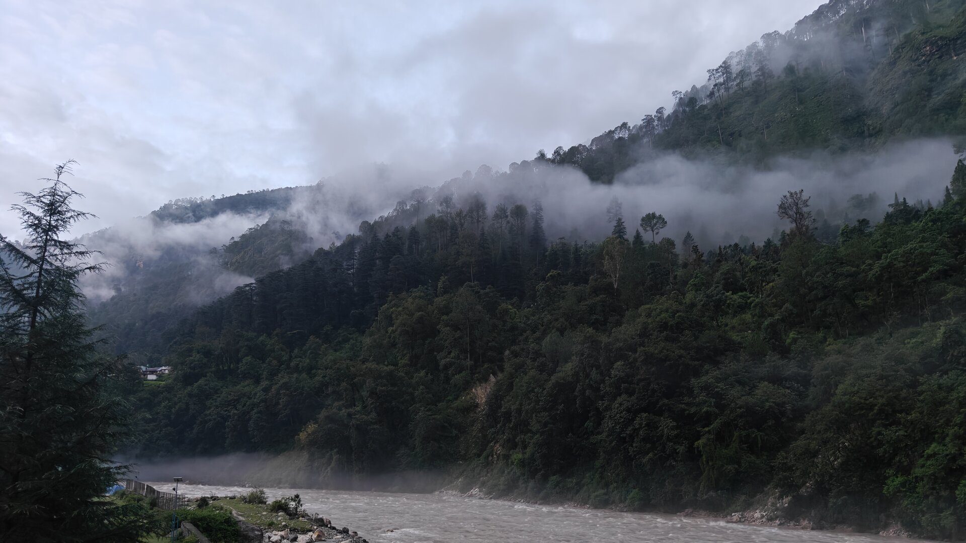 A misty Himalayan river valley near Uttarkashi at dusk